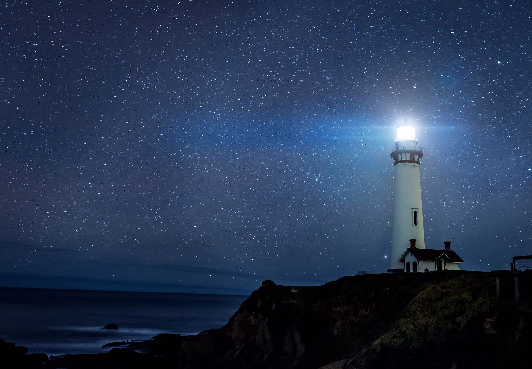 Lighthouse beacon shining at night